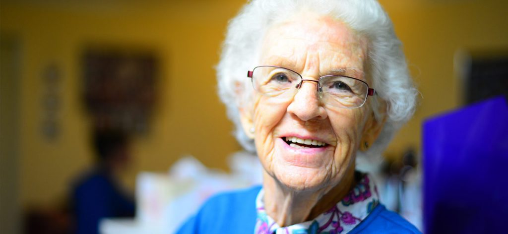 Elderly woman looking towards viewer.