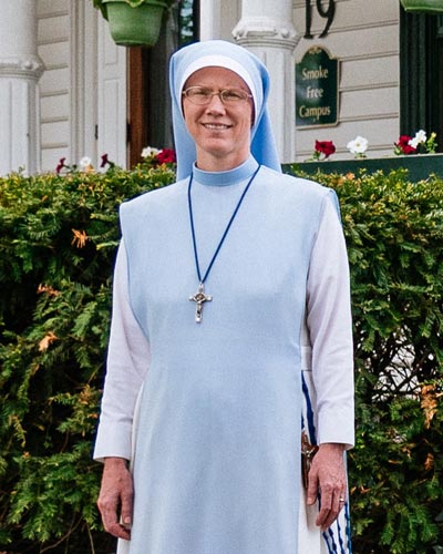 sr. mary agnes Dombroski stands in front of the st charles school