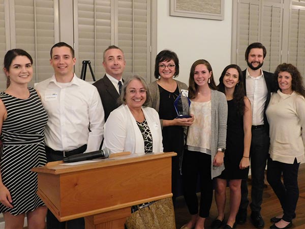 'In His Footsteps' award winner Nicole Plourde poses with her family at the 2019 CCNH Annual Gathering.