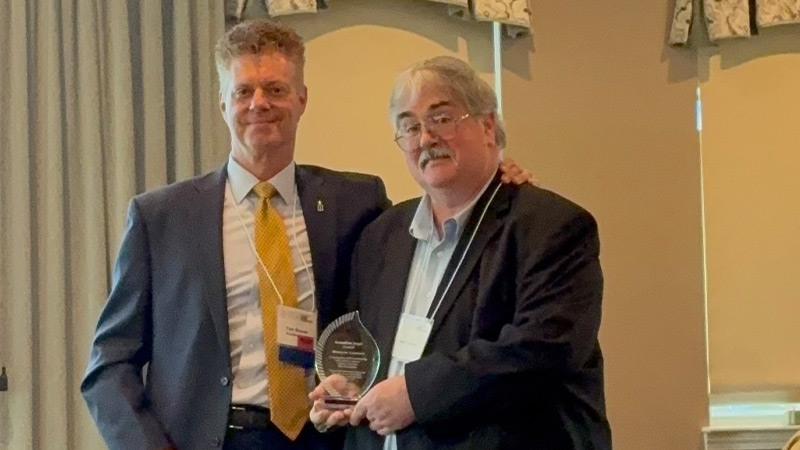 Matt Connors stans with CCNH president & CEO Tom Blonski after accepting the "In His Footsteps Award" at the 2026 Annual Gathering.